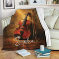 Violin throw blanket styled on a sofa with books and cozy living room decor