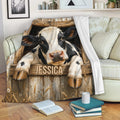 Rustic cow blanket draped over a sofa with farmhouse artwork and a cozy living room setting