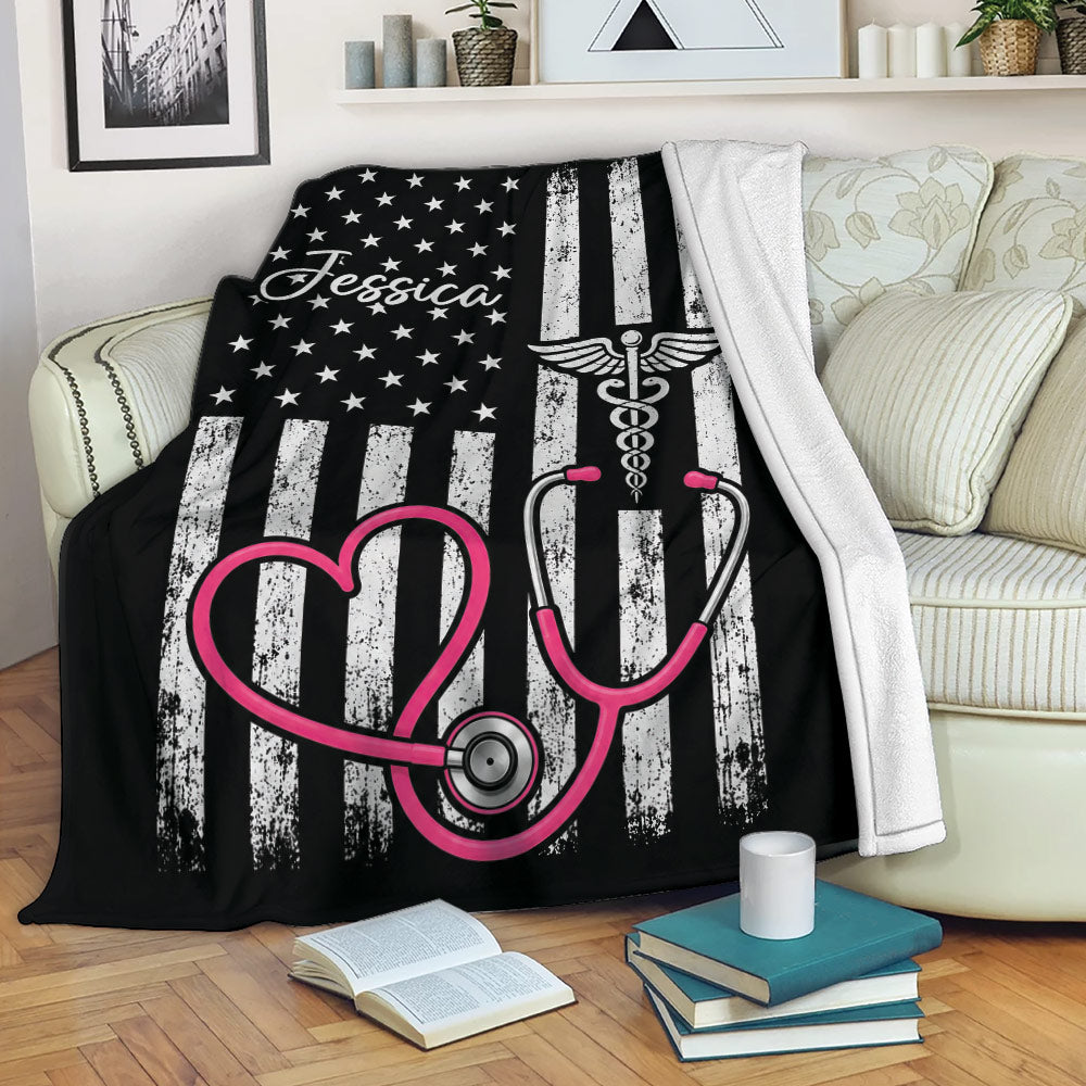 Nurse blanket draped over a sofa with stethoscope artwork and bold black, white, and pink colors