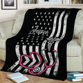 Nurse throw blanket displayed on a couch with stethoscope and patriotic flag-inspired design