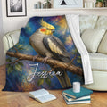Cockatiel throw blanket displayed on a living room sofa with vibrant painterly bird artwork