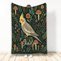 Cockatiel throw blanket with botanical foliage, mushrooms, flowers, and dark vintage-inspired artwork