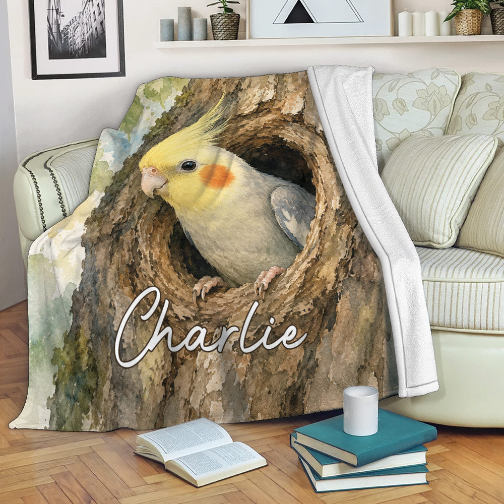 Cockatiel throw blanket displayed on a sofa with detailed watercolor bird and tree artwork
