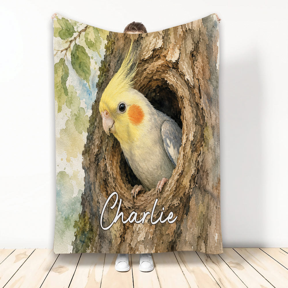 Watercolor cockatiel blanket featuring a yellow bird perched inside a textured tree hollow