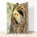 Watercolor cockatiel blanket featuring a yellow bird perched inside a textured tree hollow