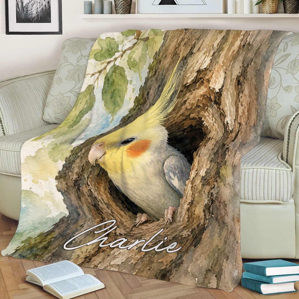 Close lifestyle view of a watercolor cockatiel blanket draped over a living room sofa