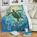 Ocean sea turtle blanket draped over a sofa with vibrant blue, teal, and gold artwork