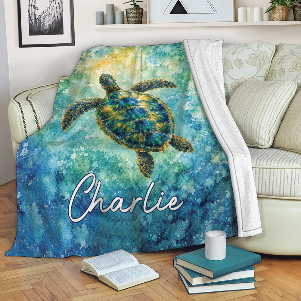 Ocean sea turtle blanket draped over a sofa with vibrant blue, teal, and gold artwork