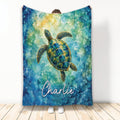 Sea turtle throw blanket with colorful blue and green watercolor ocean artwork displayed upright