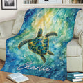 Colorful sea turtle throw blanket styled across a sofa with flowing watercolor ocean artwork