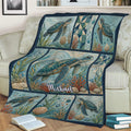 Turtle throw blanket displayed on a couch with sea turtles, shells, coral, and flowing water patterns