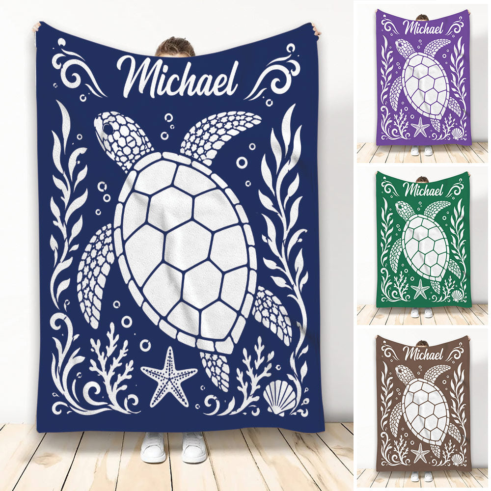 Navy turtle throw blanket with sea turtle artwork, coral, shells, starfish, and decorative ocean motifs