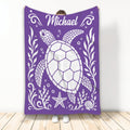 Purple turtle throw blanket featuring a large sea turtle, starfish, shells, and ocean-inspired artwork