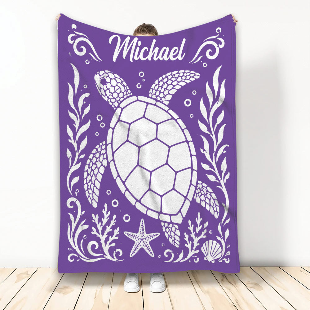 Purple turtle throw blanket featuring a large sea turtle, starfish, shells, and ocean-inspired artwork