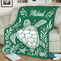 Green sea turtle blanket displayed on a sofa with coral, shells, starfish, and coastal decorative artwork