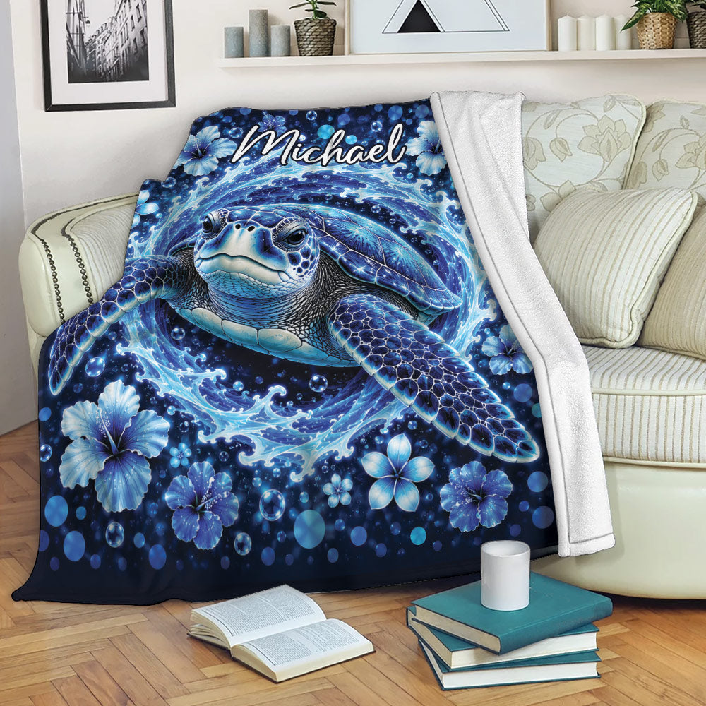 Sea turtle throw blanket displayed on a sofa with blue ocean artwork and tropical flowers
