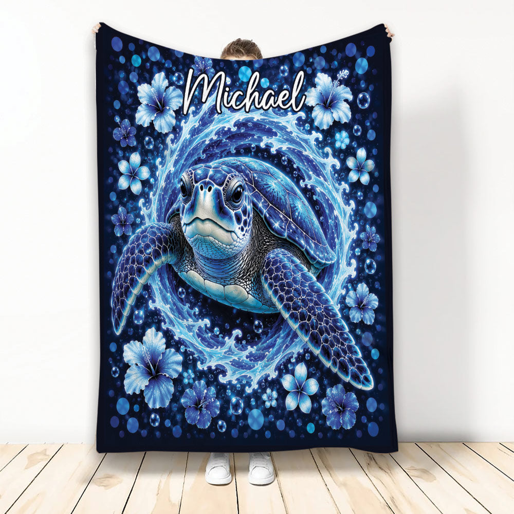 Blue sea turtle blanket with ocean waves, hibiscus flowers, bubbles, and deep navy artwork
