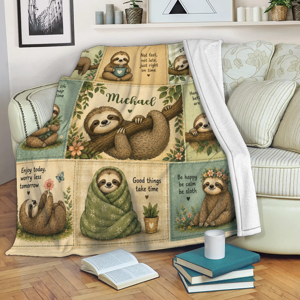 Sloth throw blanket draped over a sofa with rustic patchwork artwork and relaxing illustrated sloth scenes