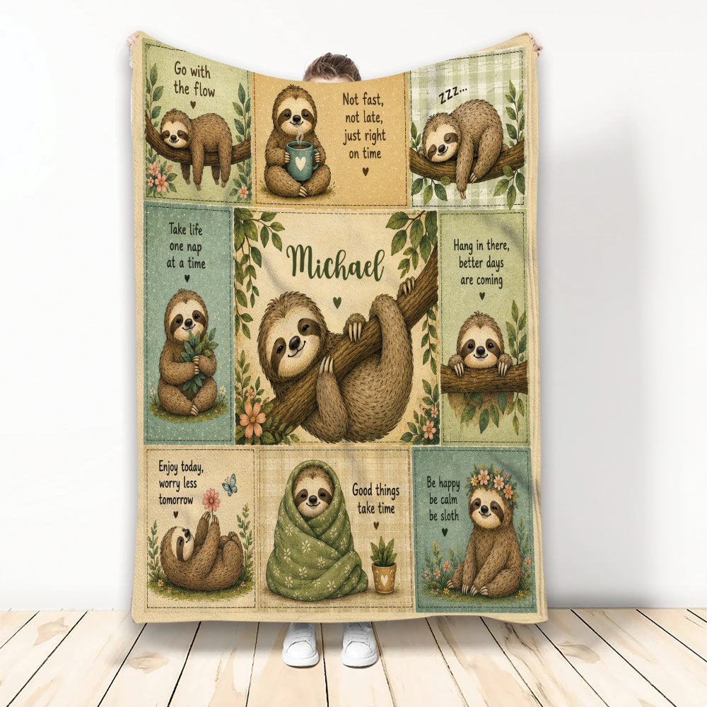 Sloth throw blanket displayed vertically with cozy illustrated sloths, leafy accents, flowers, and calming messages