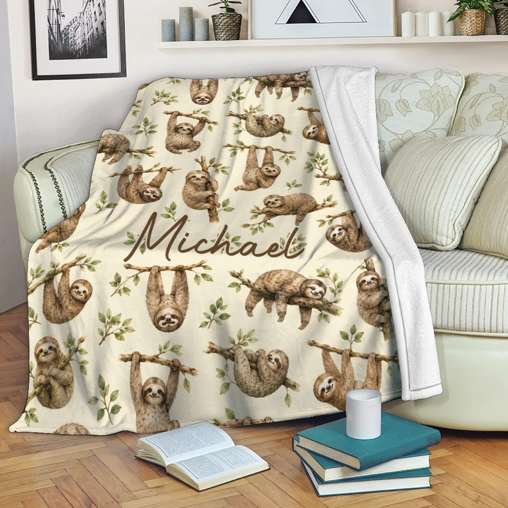 Sloth blanket draped over a sofa, featuring playful sloths and leafy branches in a cozy room
