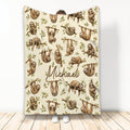 Sloth throw blanket with watercolor-style sloths on leafy branches in a warm neutral design