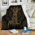 Black and gold giraffe blanket draped over a living room sofa with a cozy reading setup