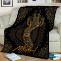 Ornate giraffe throw blanket displayed across a sofa with black and gold wildlife artwork