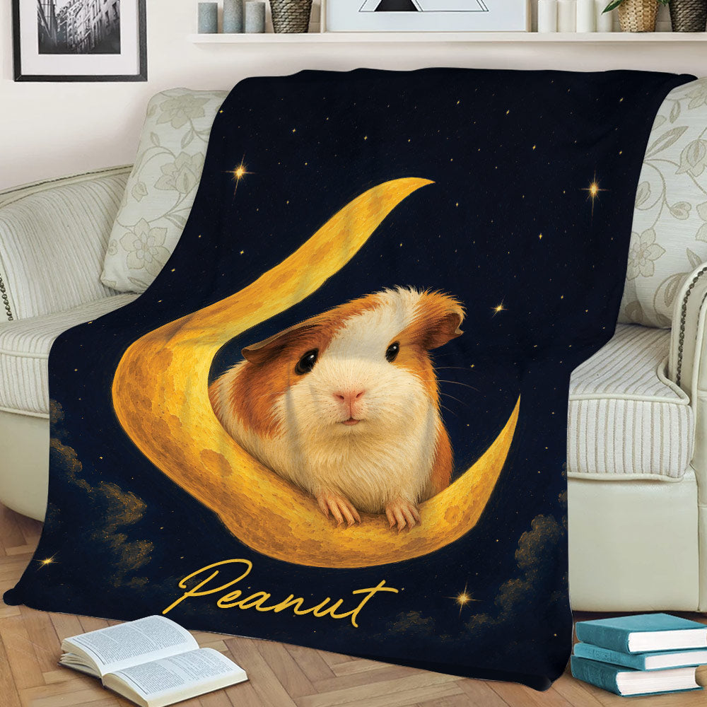 Celestial guinea pig blanket displayed on a couch with a guinea pig nestled in a golden crescent moon