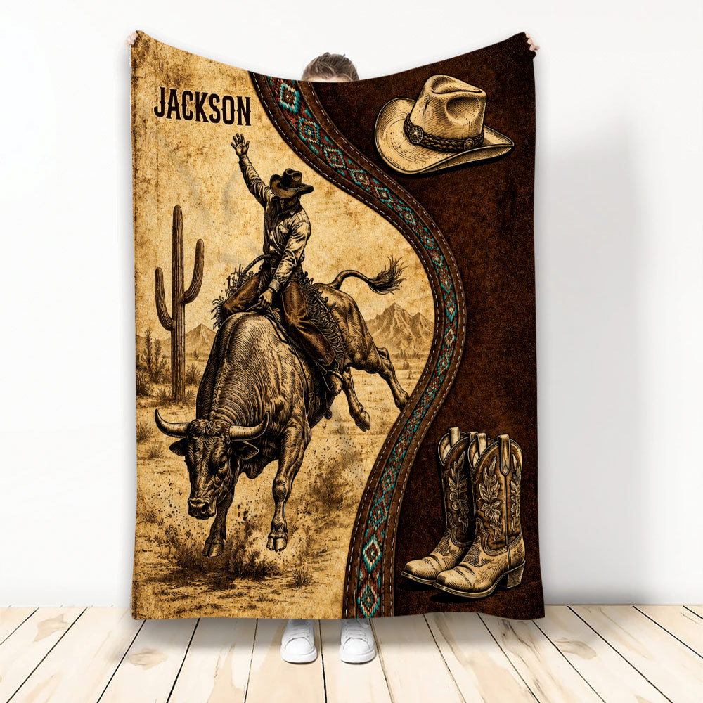 Rodeo throw blanket featuring a bull rider, cowboy hat, boots, desert scenery, and rustic western artwork