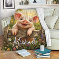 Pig throw blanket draped over a sofa with a smiling piglet, barn, wildflowers, and sunset artwork