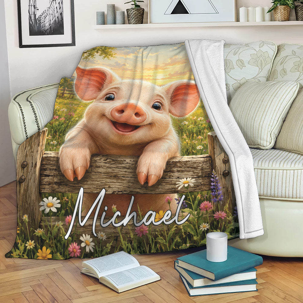 Pig throw blanket draped over a sofa with a smiling piglet, barn, wildflowers, and sunset artwork