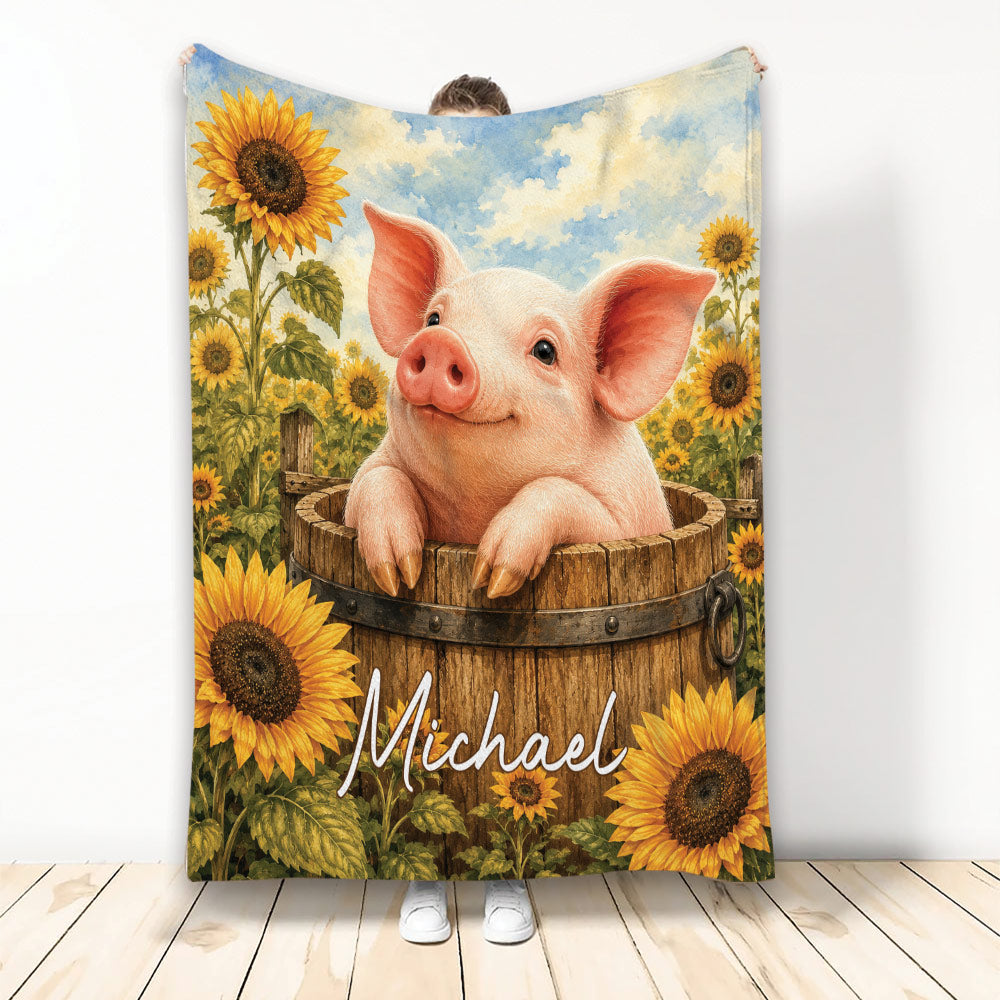 Pig blanket featuring a smiling pig in a wooden barrel surrounded by bright sunflowers and blue sky