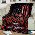 Close lifestyle view of a firefighter throw blanket featuring a Maltese cross emblem, helmet, axes, and ladder