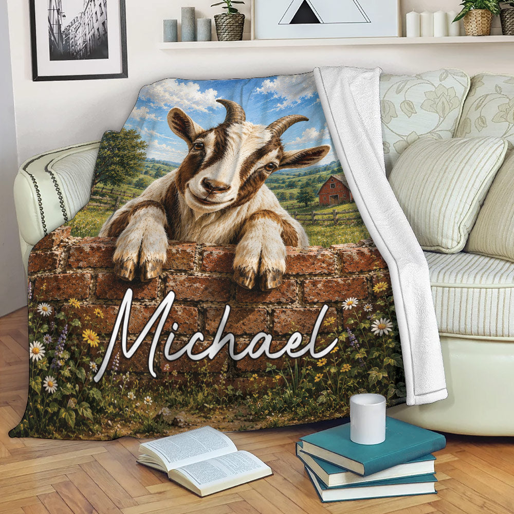 Goat blanket draped over a sofa with a horned goat, brick wall, wildflowers, and rustic farmhouse scenery