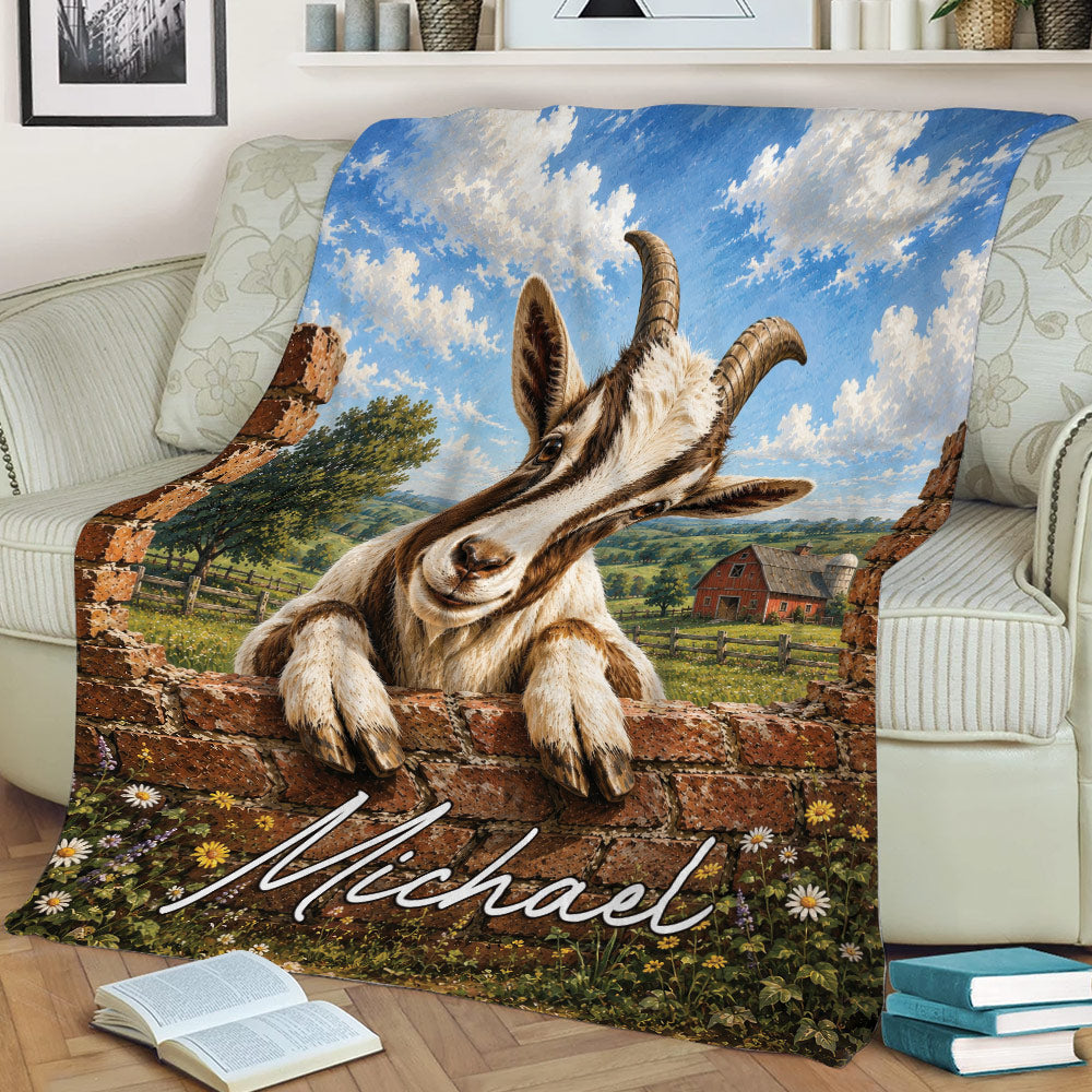Rustic goat throw blanket displayed on a sofa with a pastoral farm landscape, brick wall, and colorful flowers