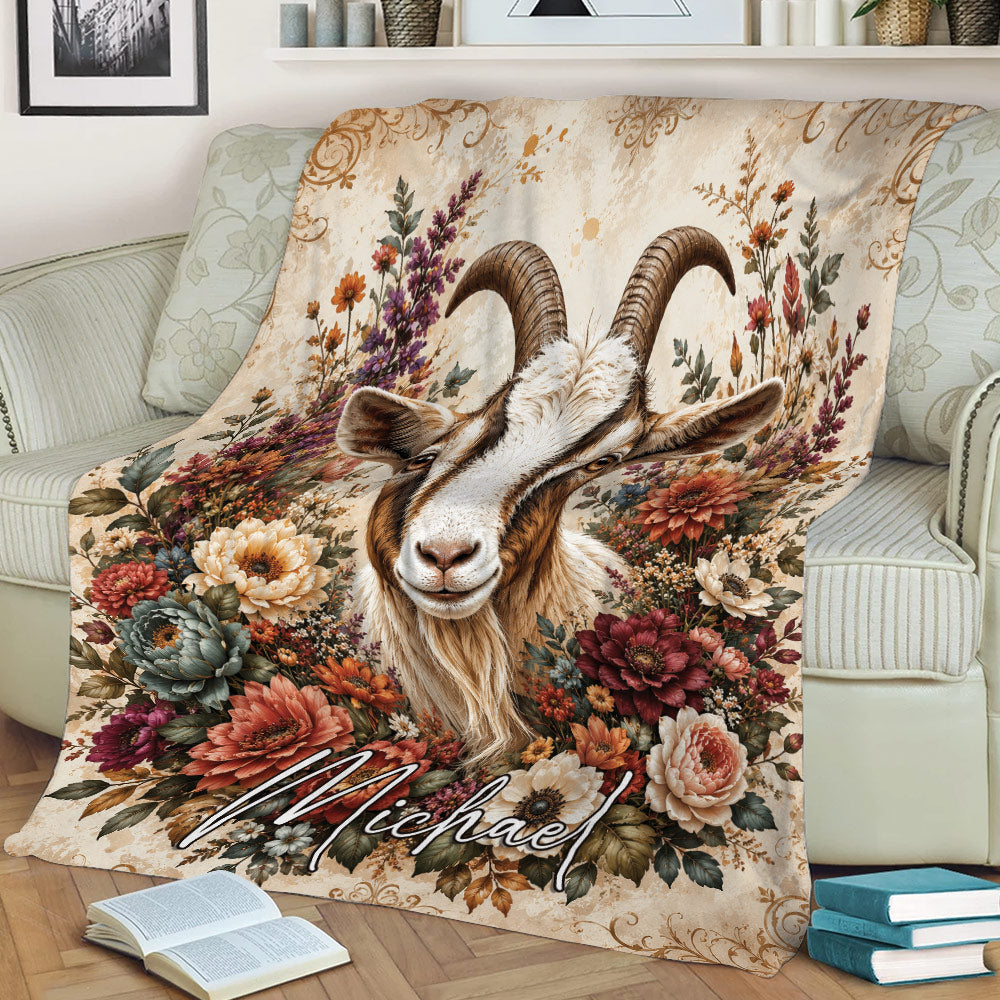 Rustic goat throw blanket displayed on a couch with a horned goat and richly colored flowers