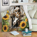 Rustic goat throw blanket draped over a sofa with barn doors, sunflowers, and three goats