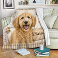 Labradoodle blanket displayed on a sofa with rustic wood artwork, paw prints, hearts, and cozy living room decor