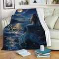 Mermaid blanket draped over a sofa, showing a moonlit ocean scene with a starry sky and blue tail