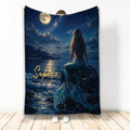 Mermaid throw blanket featuring a moonlit ocean, starry sky, castle shoreline, and shimmering blue tail