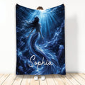 Custom mermaid blanket featuring a luminous underwater scene with flowing tail, jellyfish, bubbles, and blue ocean light