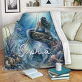 Mermaid throw blanket draped over a sofa, showing blue underwater artwork and colorful ocean life