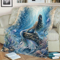 Mermaid throw blanket displayed on a couch with an underwater fantasy scene, coral, fish, and seashells