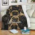 Pug throw blanket displayed on a sofa with repeating illustrated pug artwork