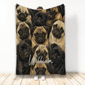 Custom pug throw blanket featuring a repeating pattern of tan and black pug faces