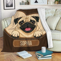 Pug blanket draped over a sofa, featuring a playful fawn pug design in warm brown tones