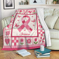 Breast cancer awareness throw blanket displayed on a sofa with pink ribbon and floral artwork