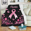 Pink ribbon breast cancer awareness throw blanket styled across a living room sofa