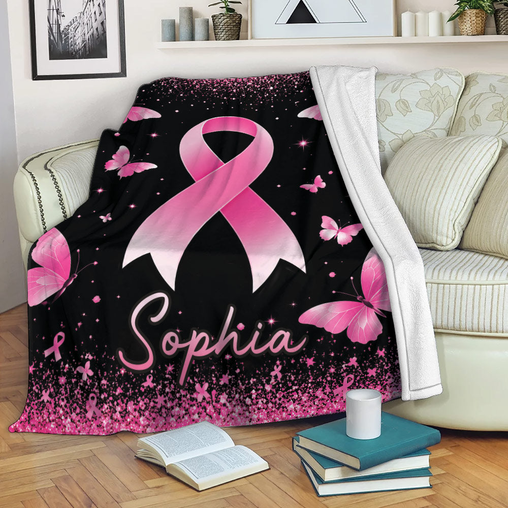 Breast cancer awareness ribbon throw blanket displayed on a sofa with pink butterflies