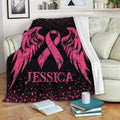 Pink breast cancer ribbon wing blanket draped over a sofa in a cozy living room
